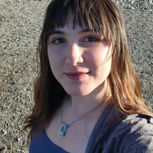 New student Vivian Van Fossen standing on some gravel with rocks behind her.