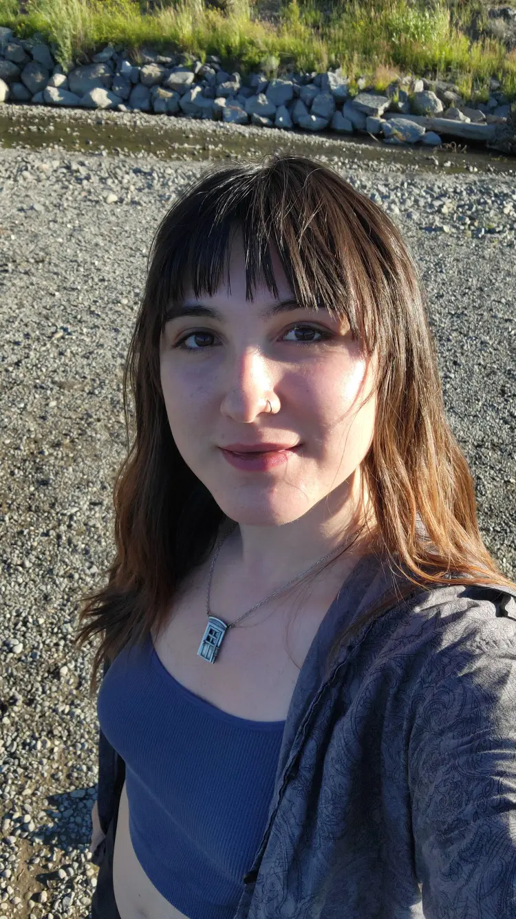 New student Vivian Van Fossen standing on some gravel with rocks behind her.