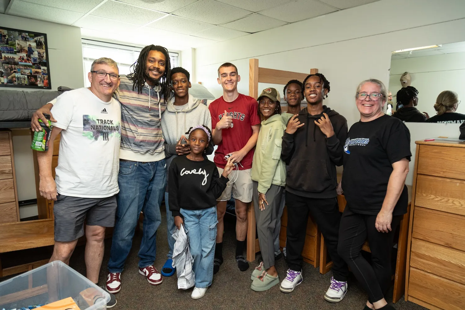 Families posing with their students in a residence hall.