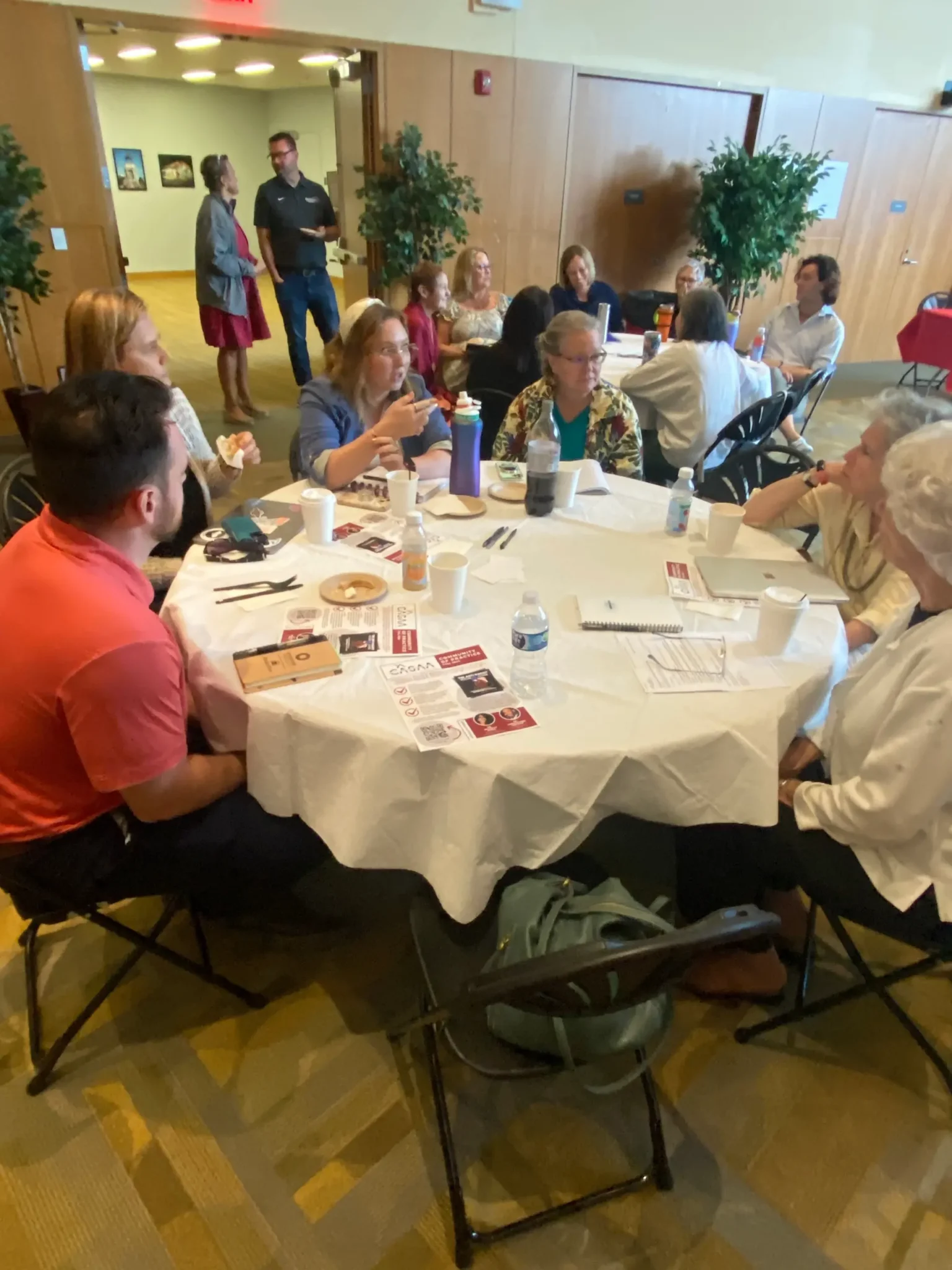 Tables of faculty and staff in the Great Room