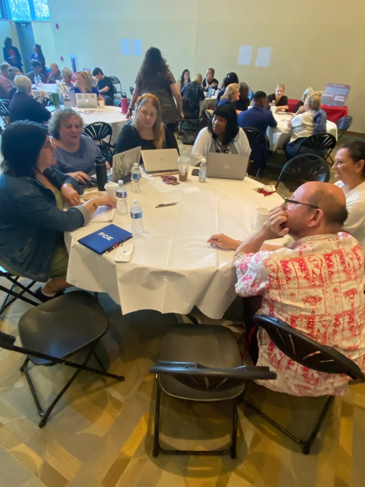 A table of faculty and staff in the Great Room