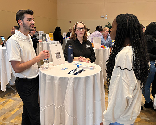 First-year student Rayven Hooten speaks with representatives from ESS.