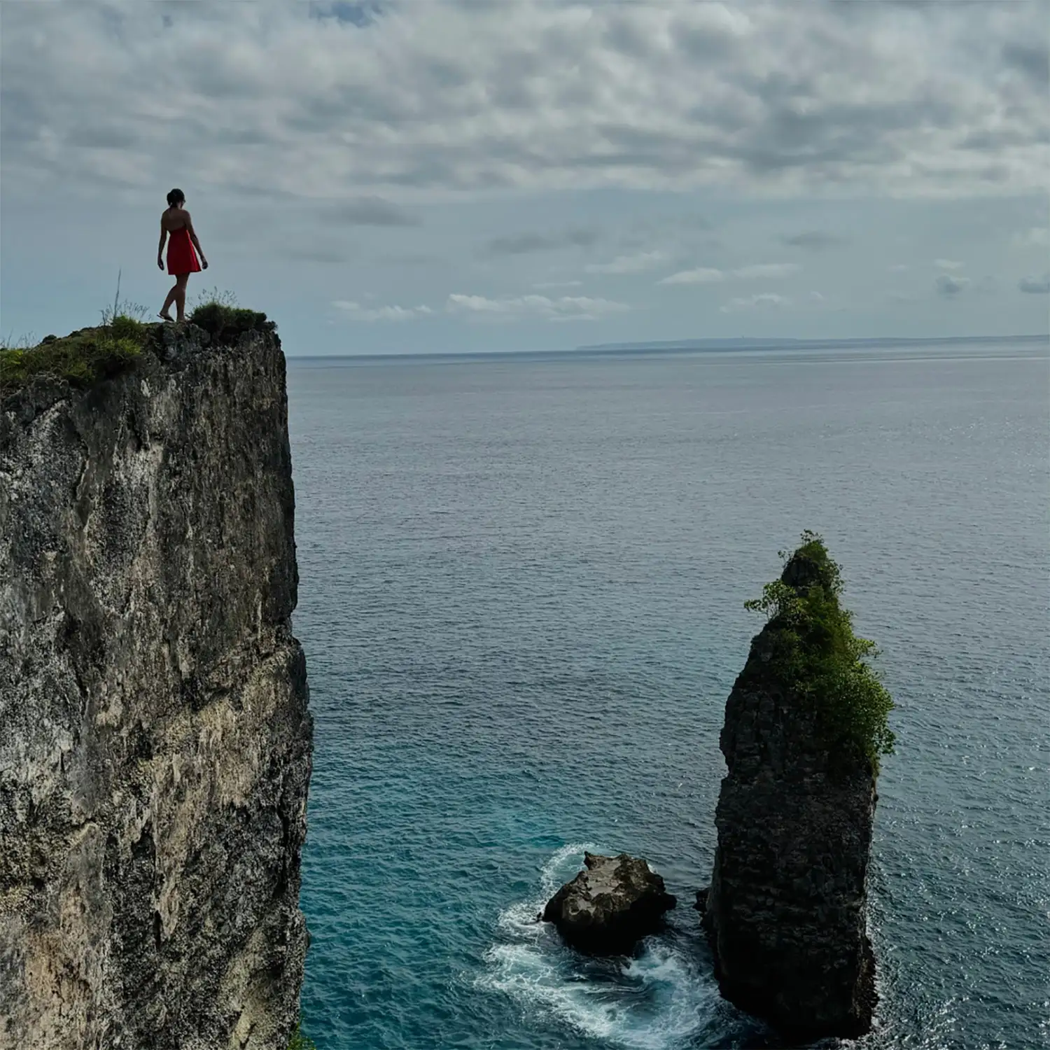 Samantha Silverglade standing on a cliff above the ocean.