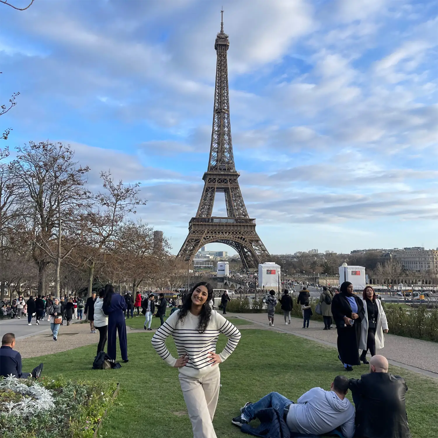 Gauri Chopra standing in front of the Eiffel Tower in Paris, France.