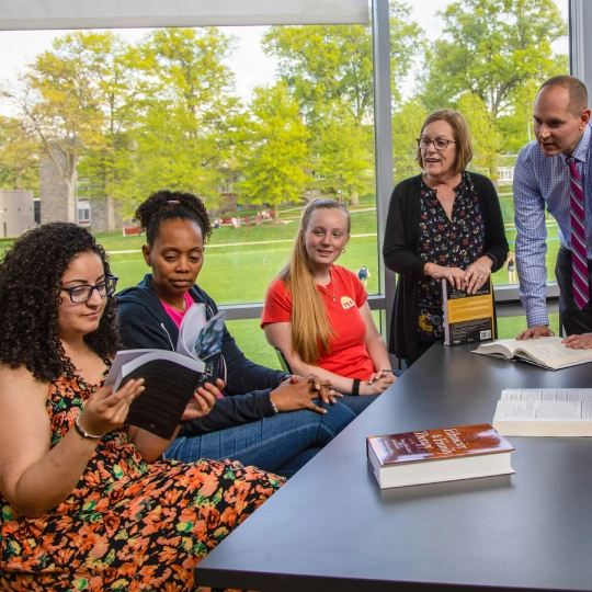 Counseling students discuss topics with professors.