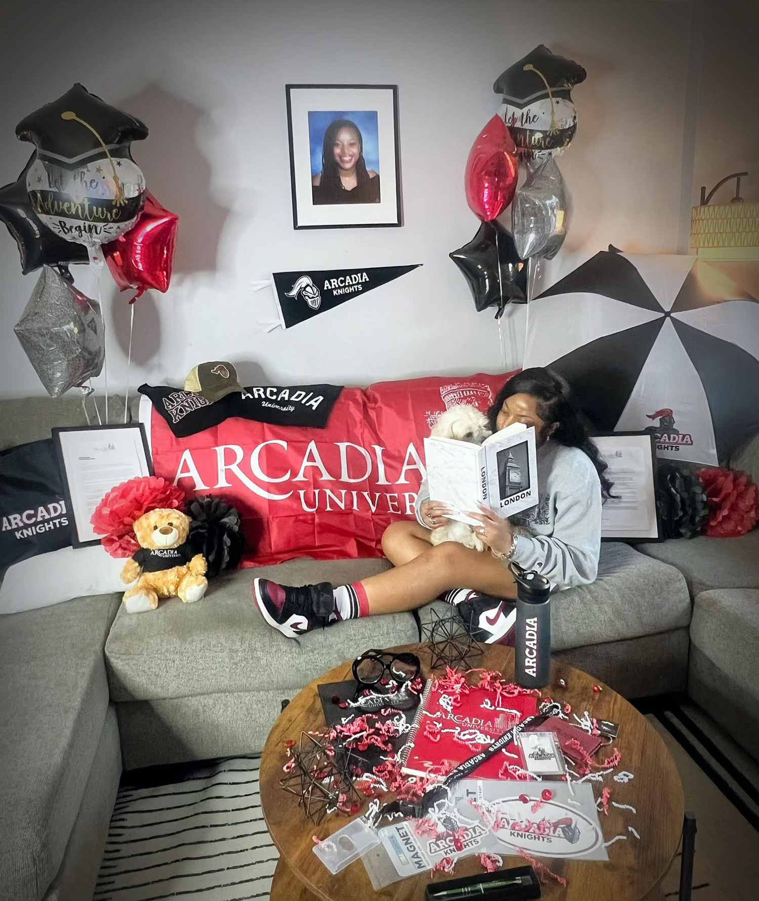 Jamai reading on a couch decorated in Arcadia gear.