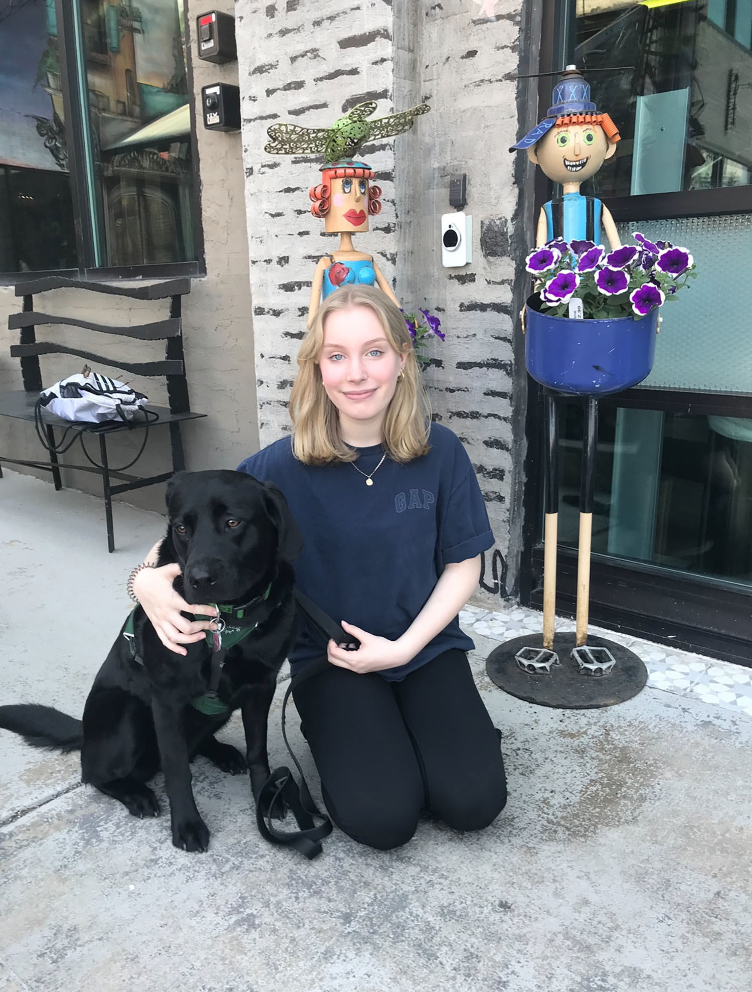 Roberti sitting next to her puppy Corrie.