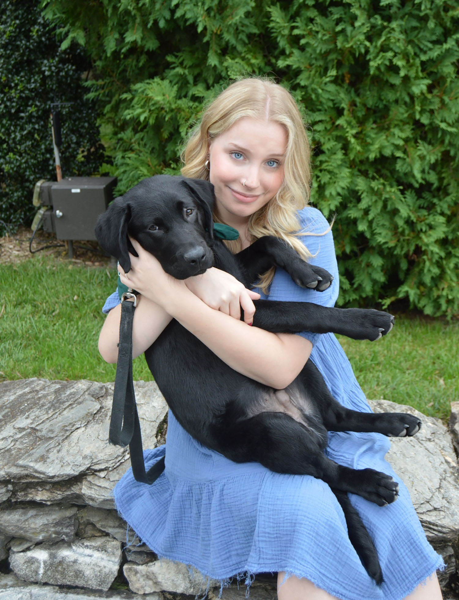 Roberti holding a Seeing Eye puppy named Kelnis.