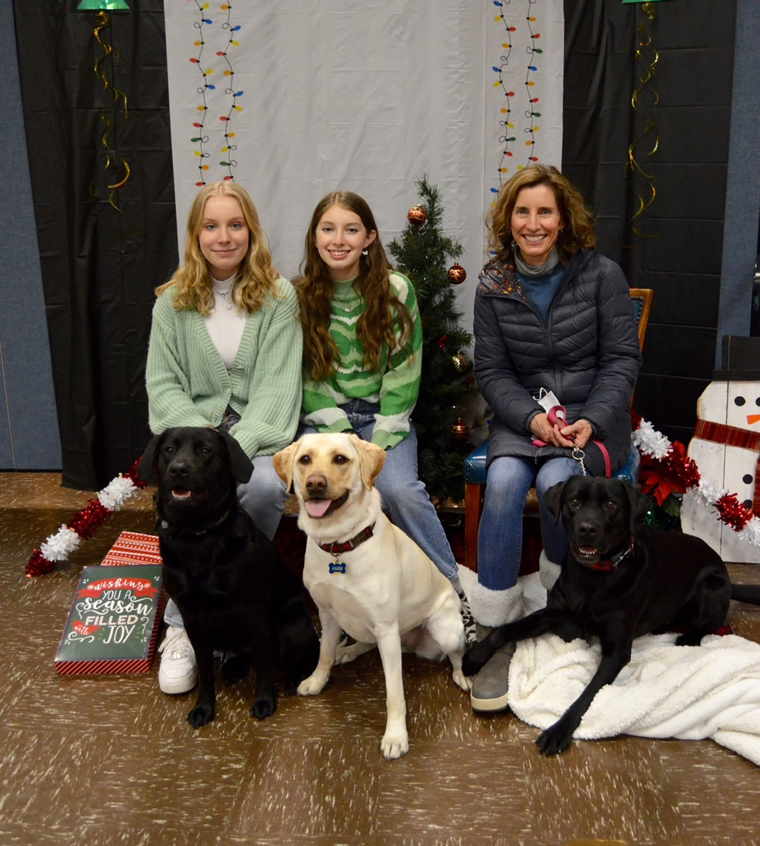 Roberti (left) with her sister (middle) and mother (right) at a Seeing Eye puppy socializing event.