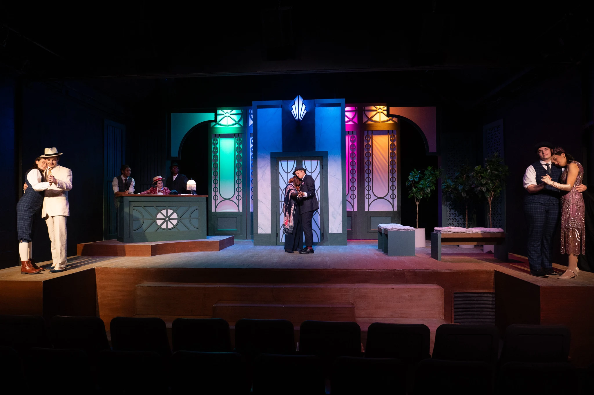 Eight actors on stage for a play.