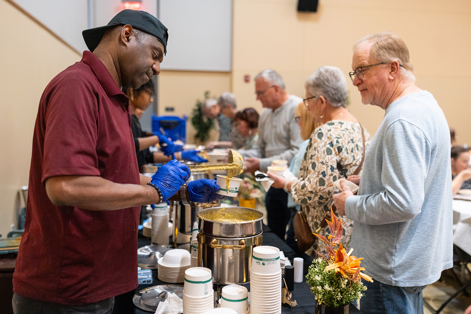 Metz staff serving guests soup.