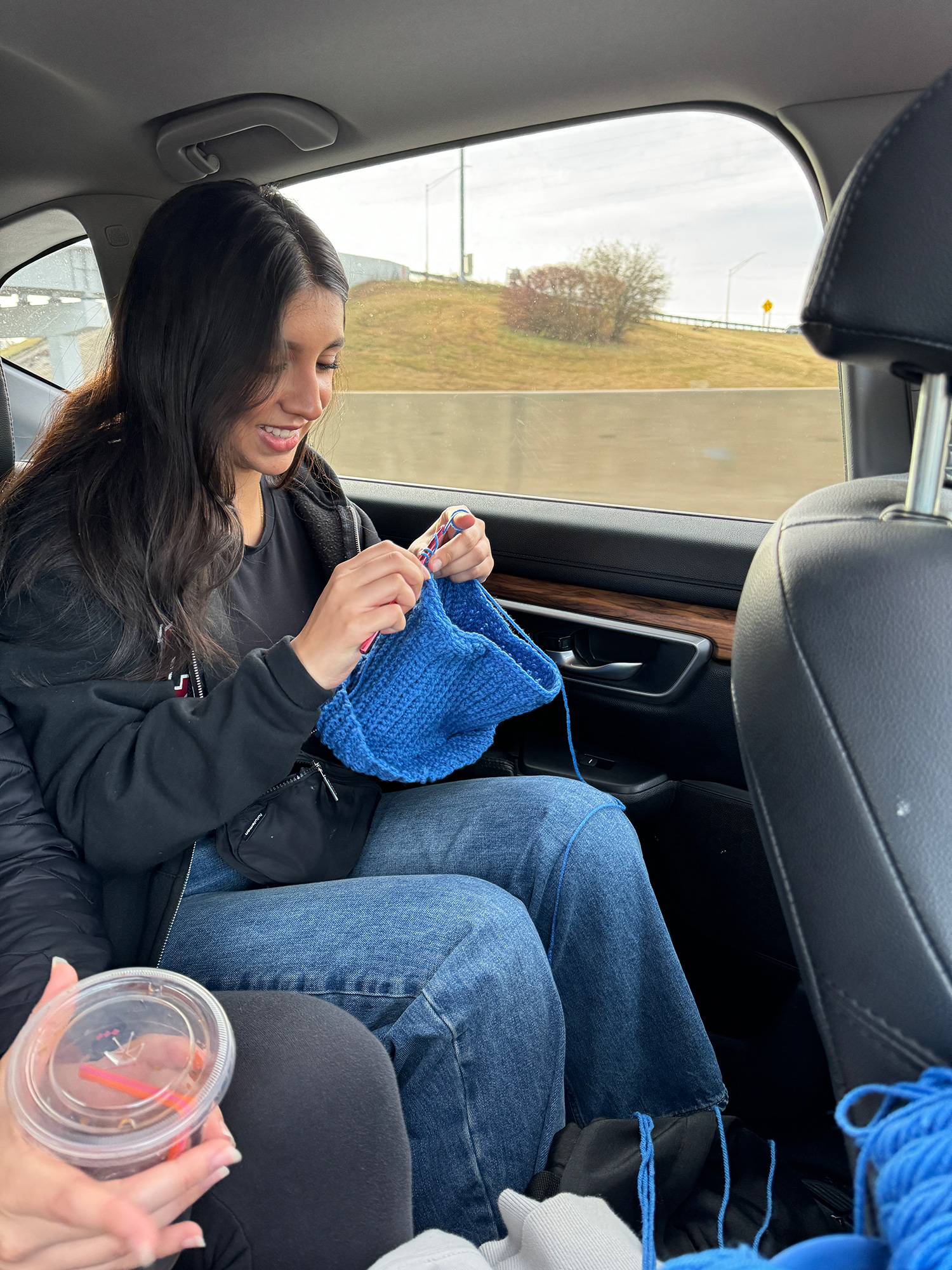 Wasim ’25 crocheting a hat in the car.