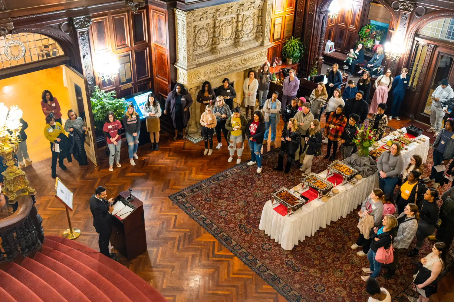 Guests listening to a speaker in the Castle lobby