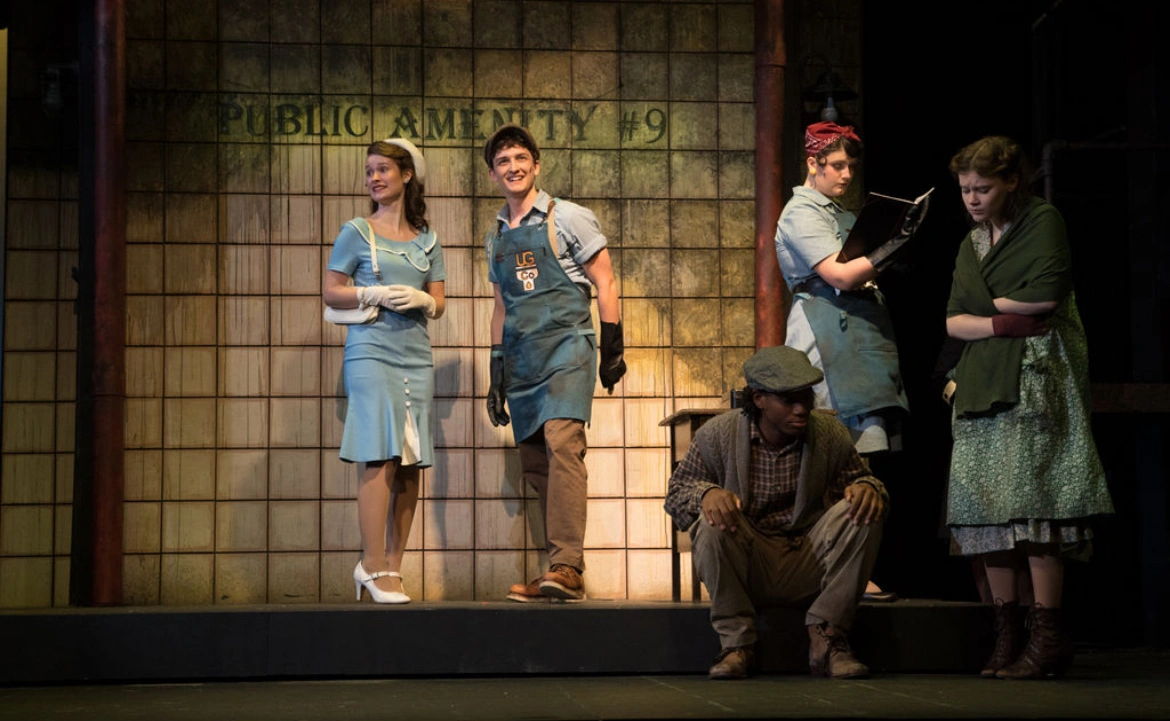 Five people on stage for a play production.