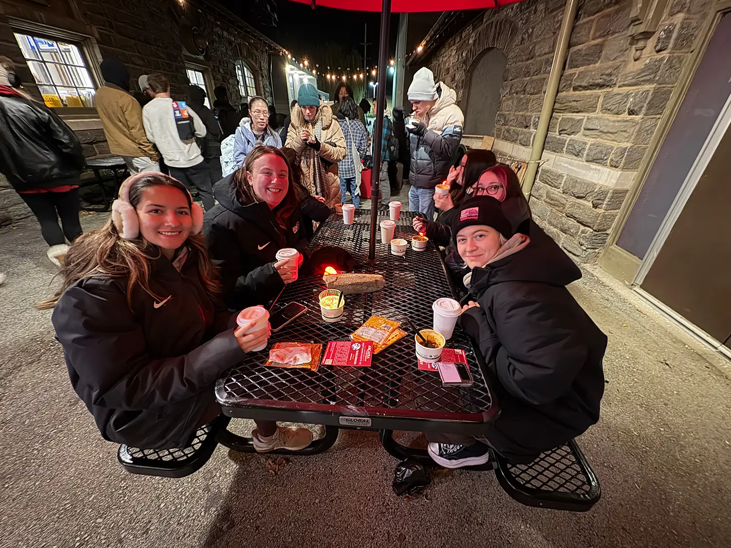 Students having hot cocoa together at a table.