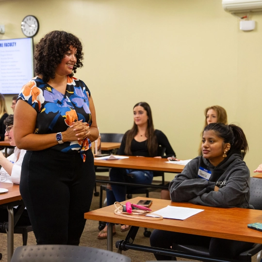 Lauren Reid, Ph.D., Director, Graduate Program in Counseling smiles as she talks to students in class.