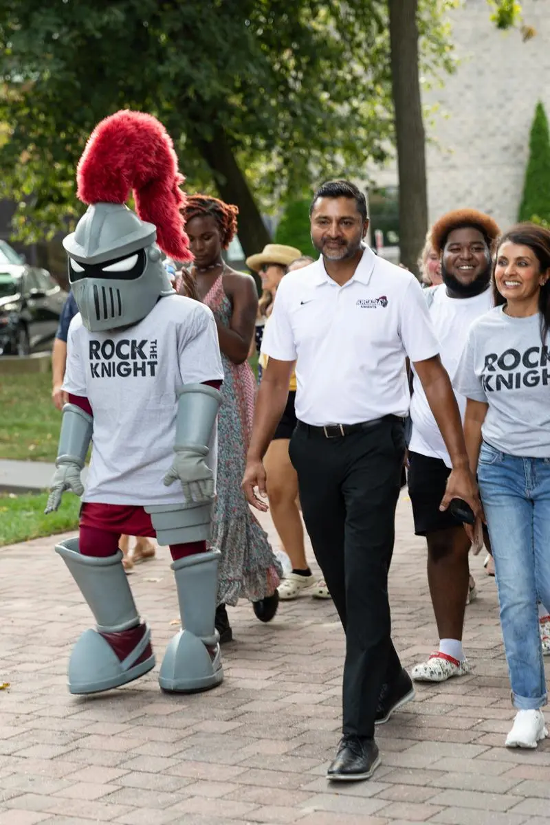 Students and President Nair (and Archie) process down to the Glenside Food Truck Festival