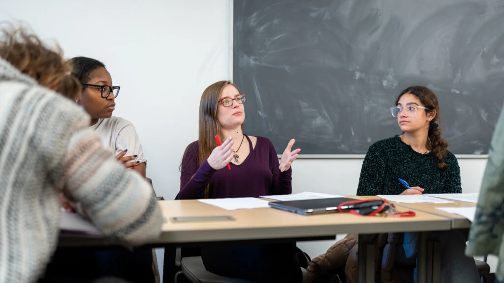 Students listen to a lecture in a political science classroom.