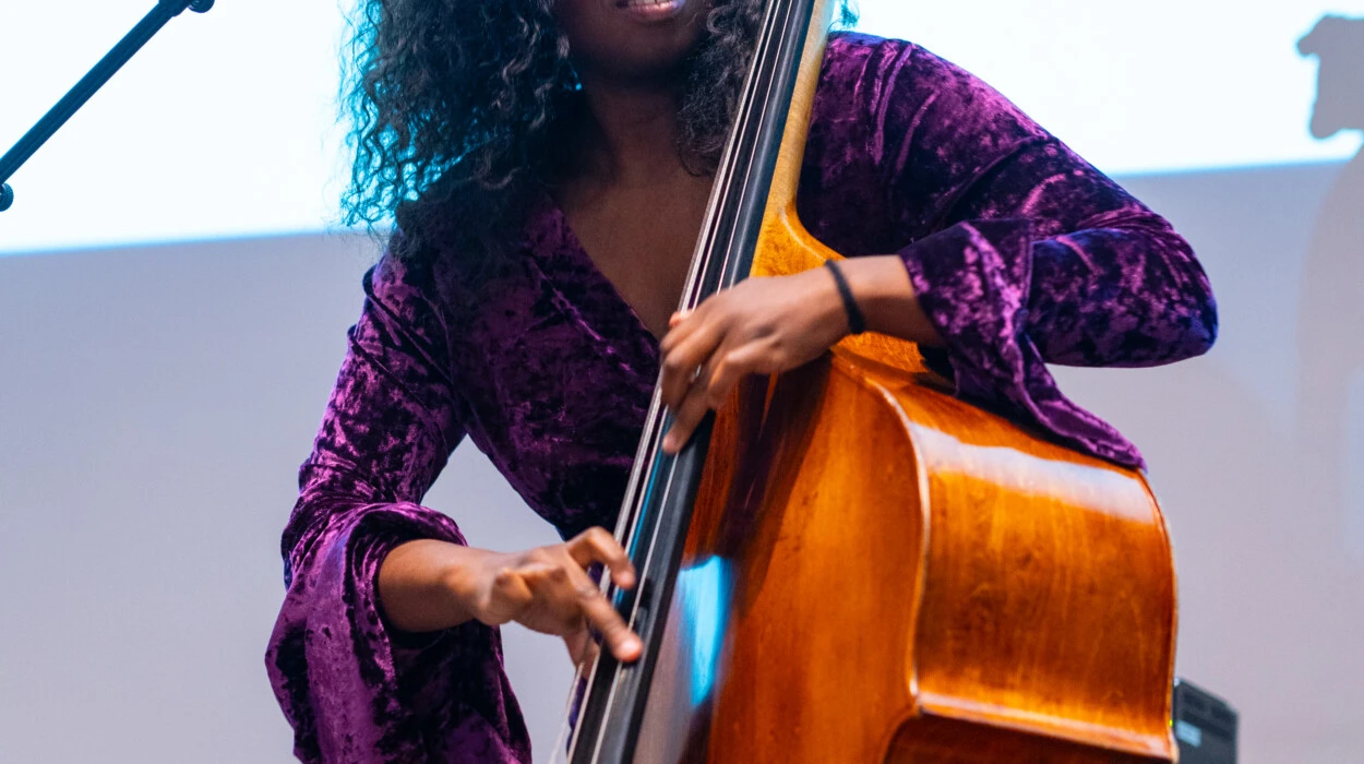 A women playing a bass onstage