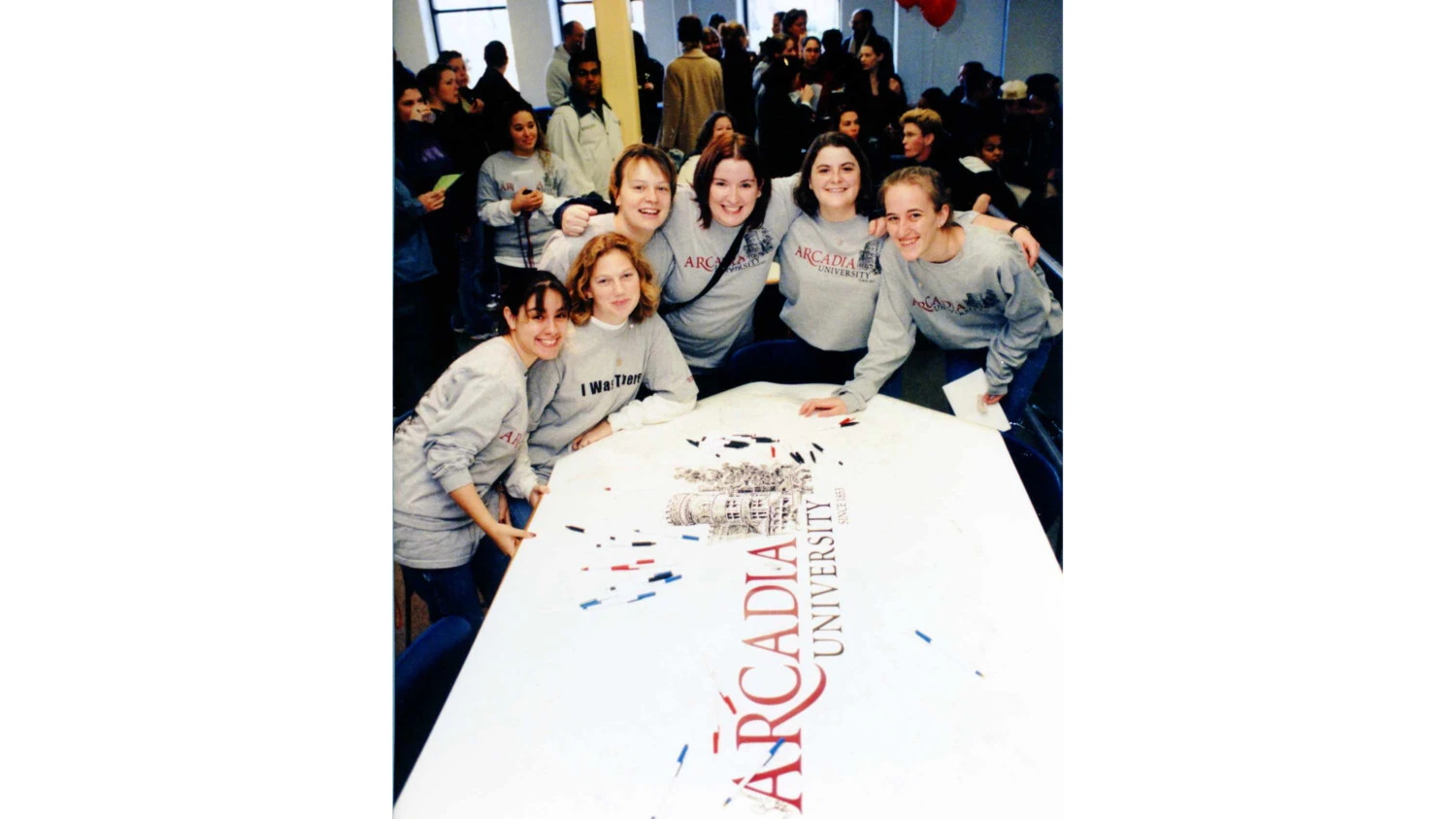 Students work on banner celebrating the name change from Beaver College to Aracadia University
