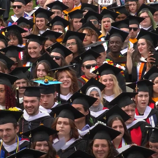 A crowd of students with caps and gowns during commencement 2022.