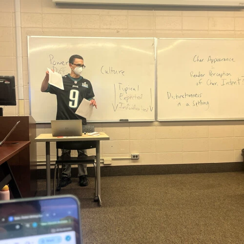 Professor Dan Schall standing in front of his classroom.