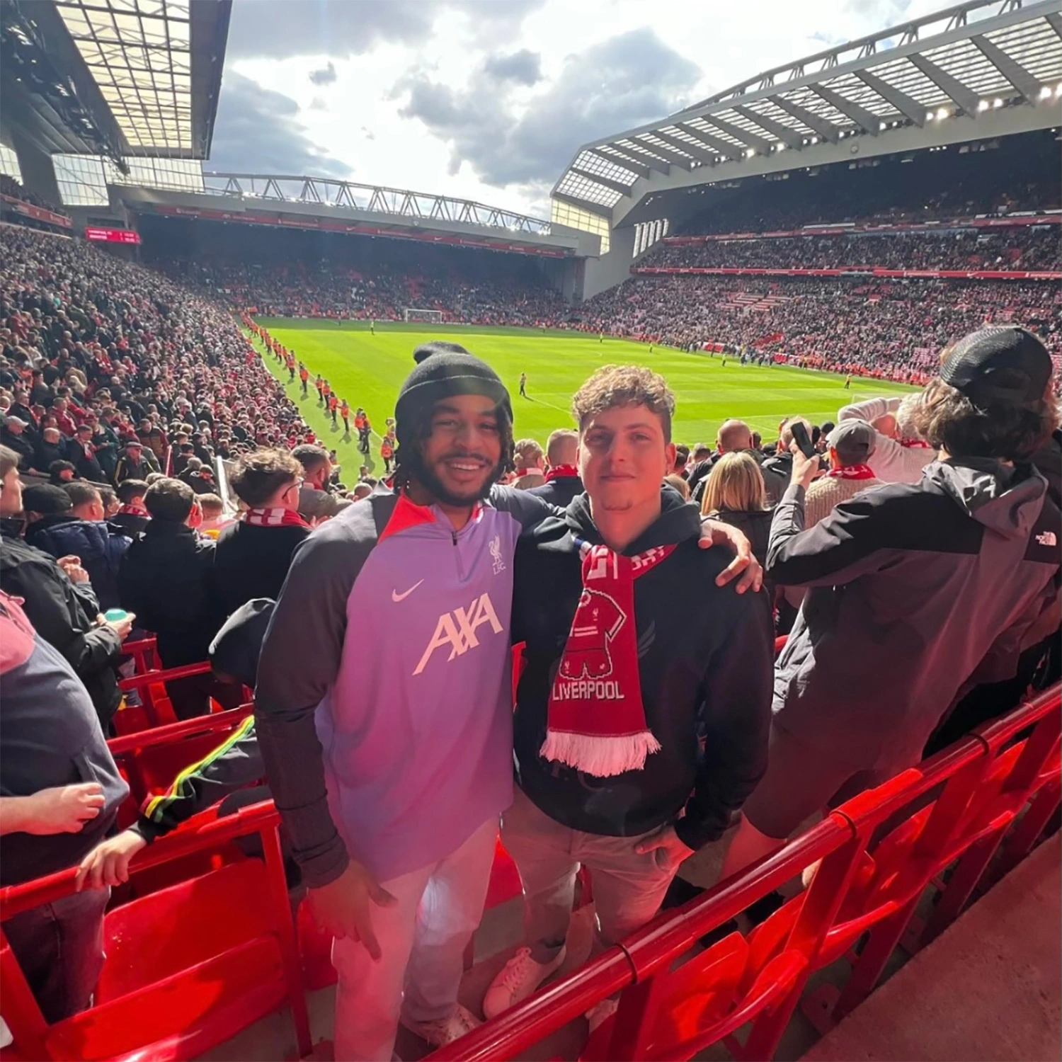 Armando Verdaro at a Liverpool soccer game with the field behind him.