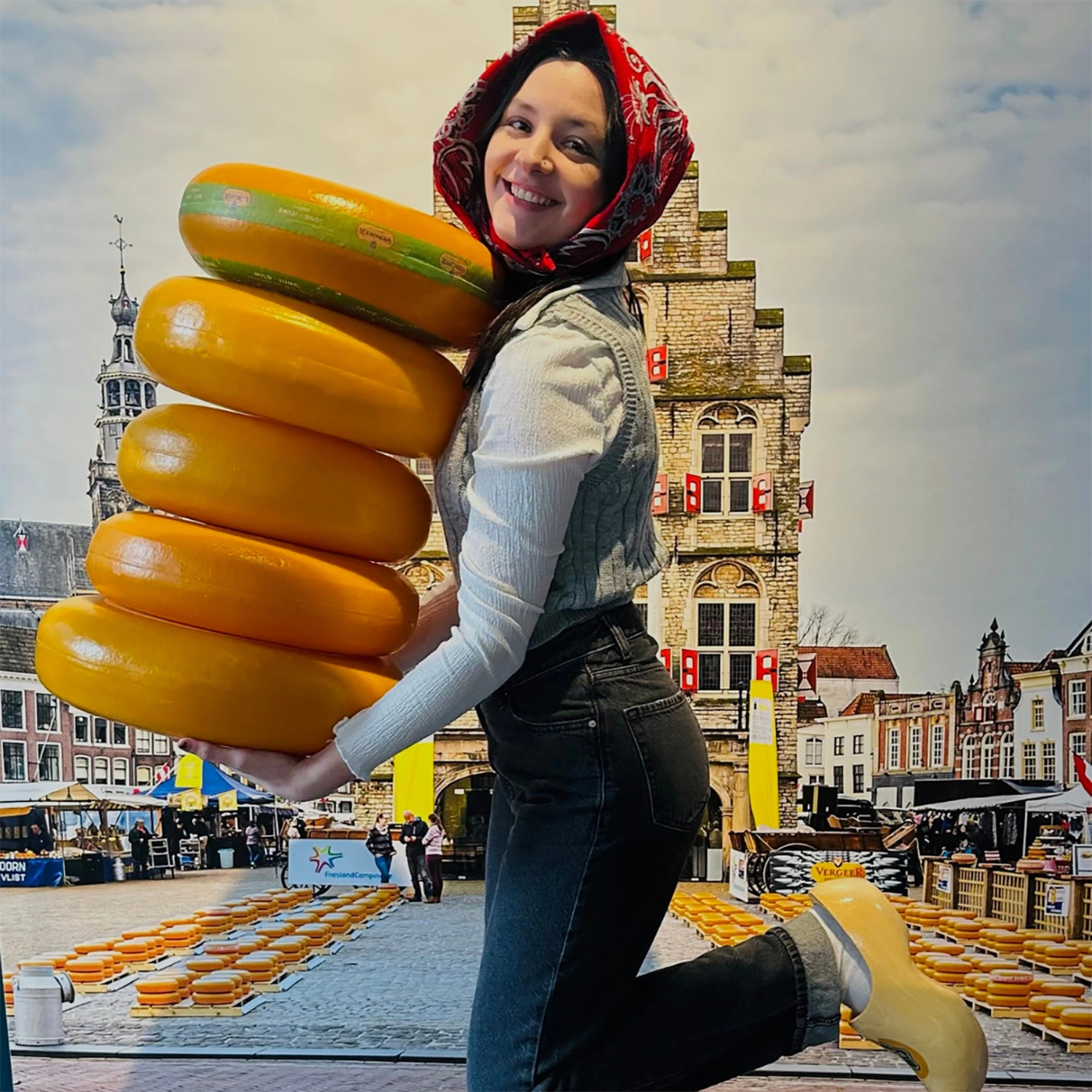 Samantha Silverglade holding a stack of cheese wheels.