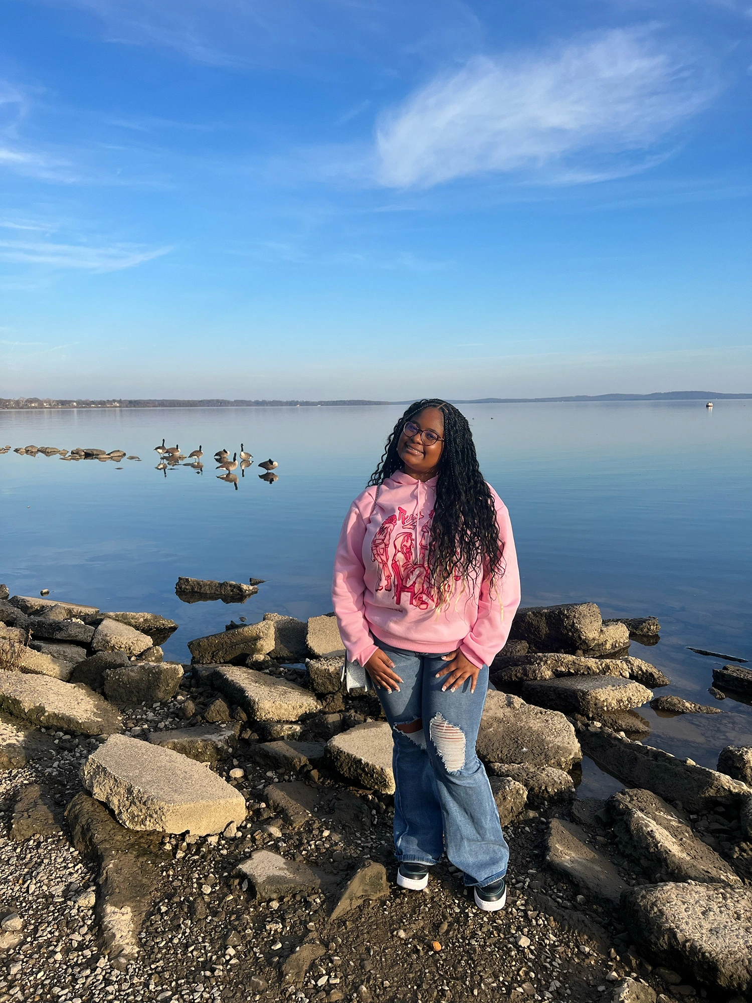 Makiyah Smith ’28 standing in front of a body of water.