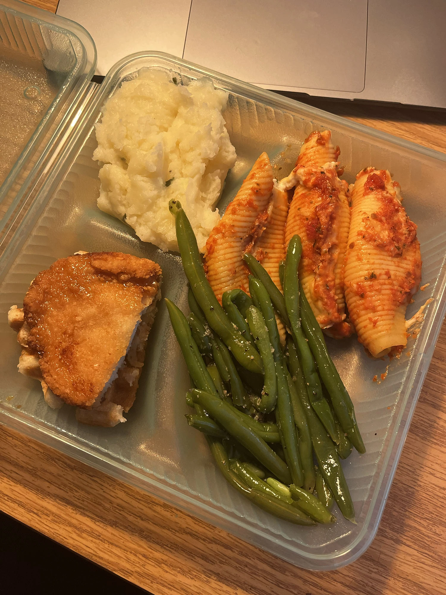 A meal in a dining hall to-go container.