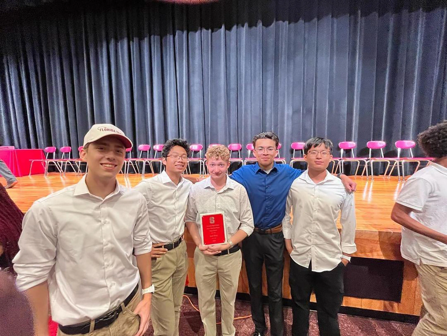 Jack Riley ’28 standing with classmates holding an award.