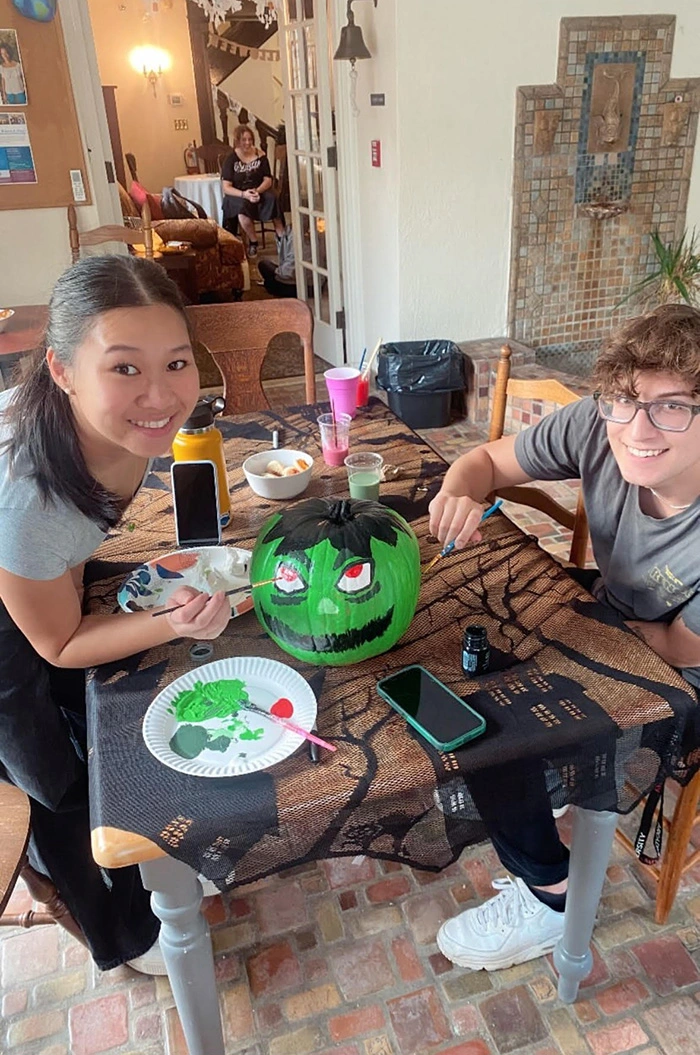 Students showing off finalized painted pumpkin