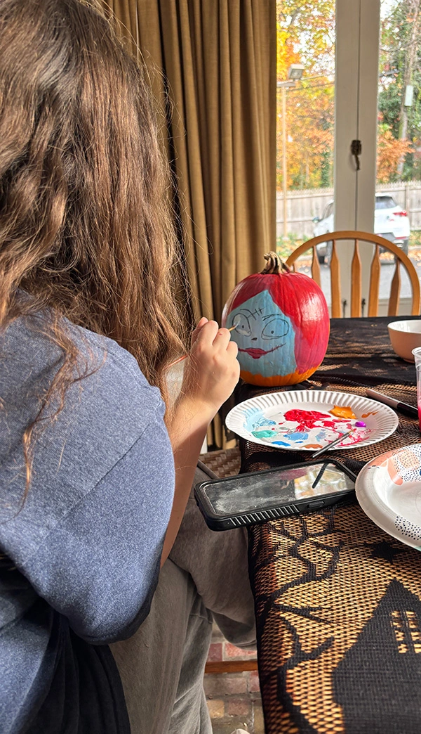 Student painting pumpkin