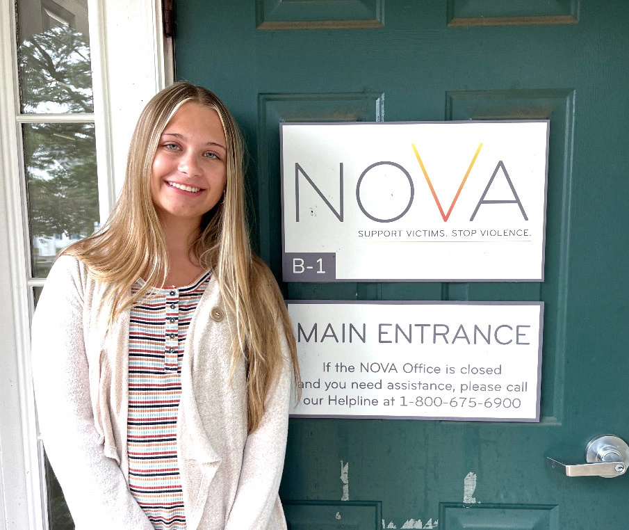 Kassidy Shaw ’27 standing at the entrance of the NOVA office in Jamison, Pa.