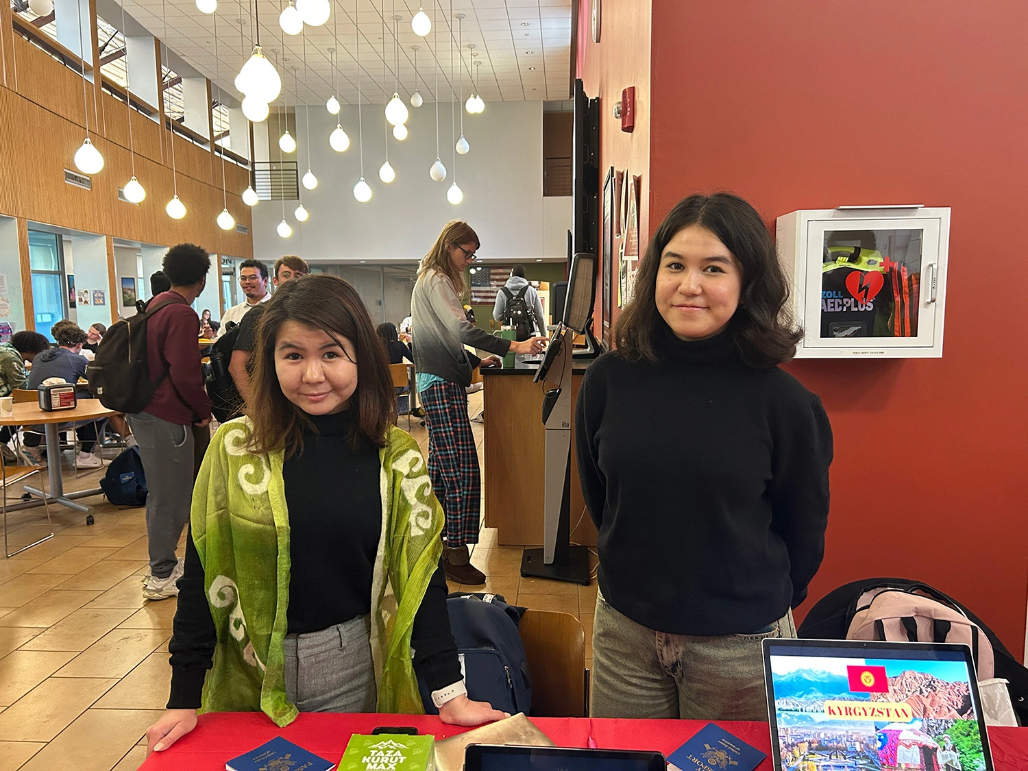 Nelly (left) and Ameliia (right) Tyncherova at the Kyrgyzstan table.