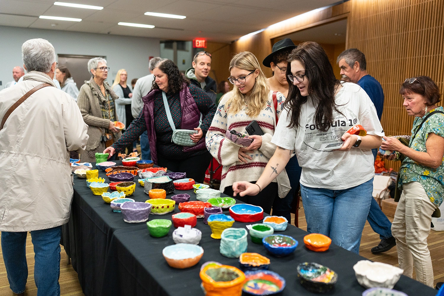 Students looking at the bowls at Empty Bowl.