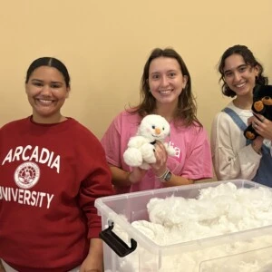 students hold stuffed animals