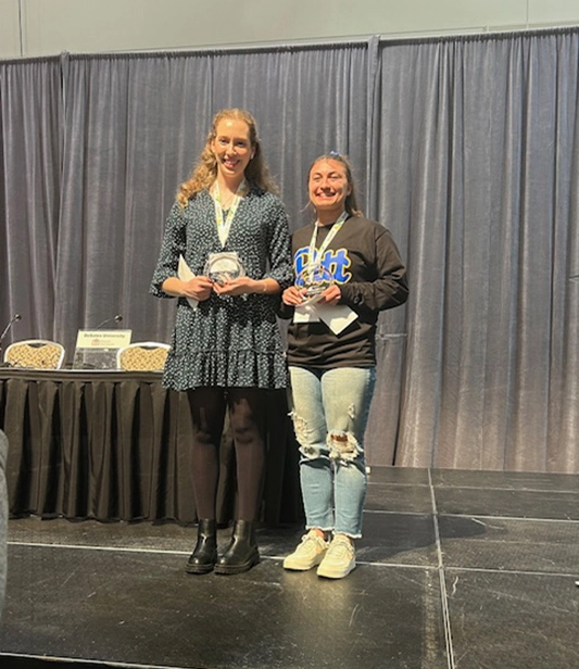 Alyea Wood accepts an plaque and recognition for the Nathaniel Alston Student Achievement Scholarship Award by the Pennsylvania Society of Physician Assistants (PSPA).