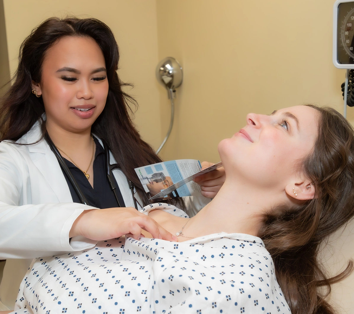 Two pyhsician assistant students work in a clinical simulation medical exam.