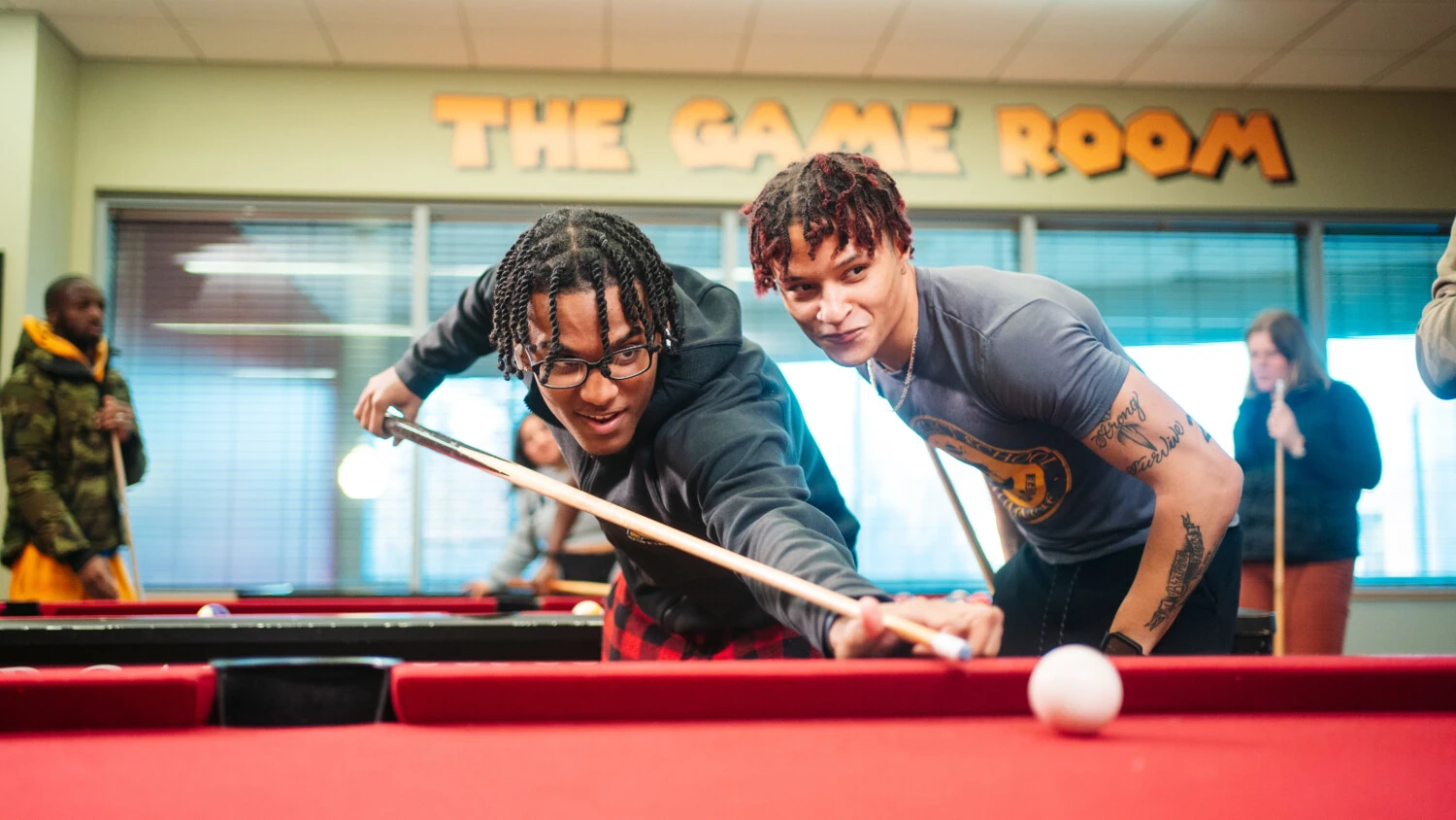 Students playing pool table together