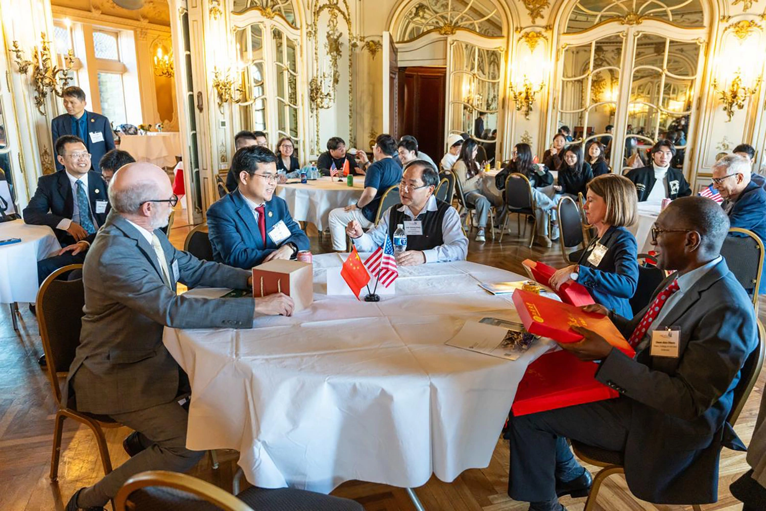 Leadership from Arcadia and Jiangsu University sitting at a table.