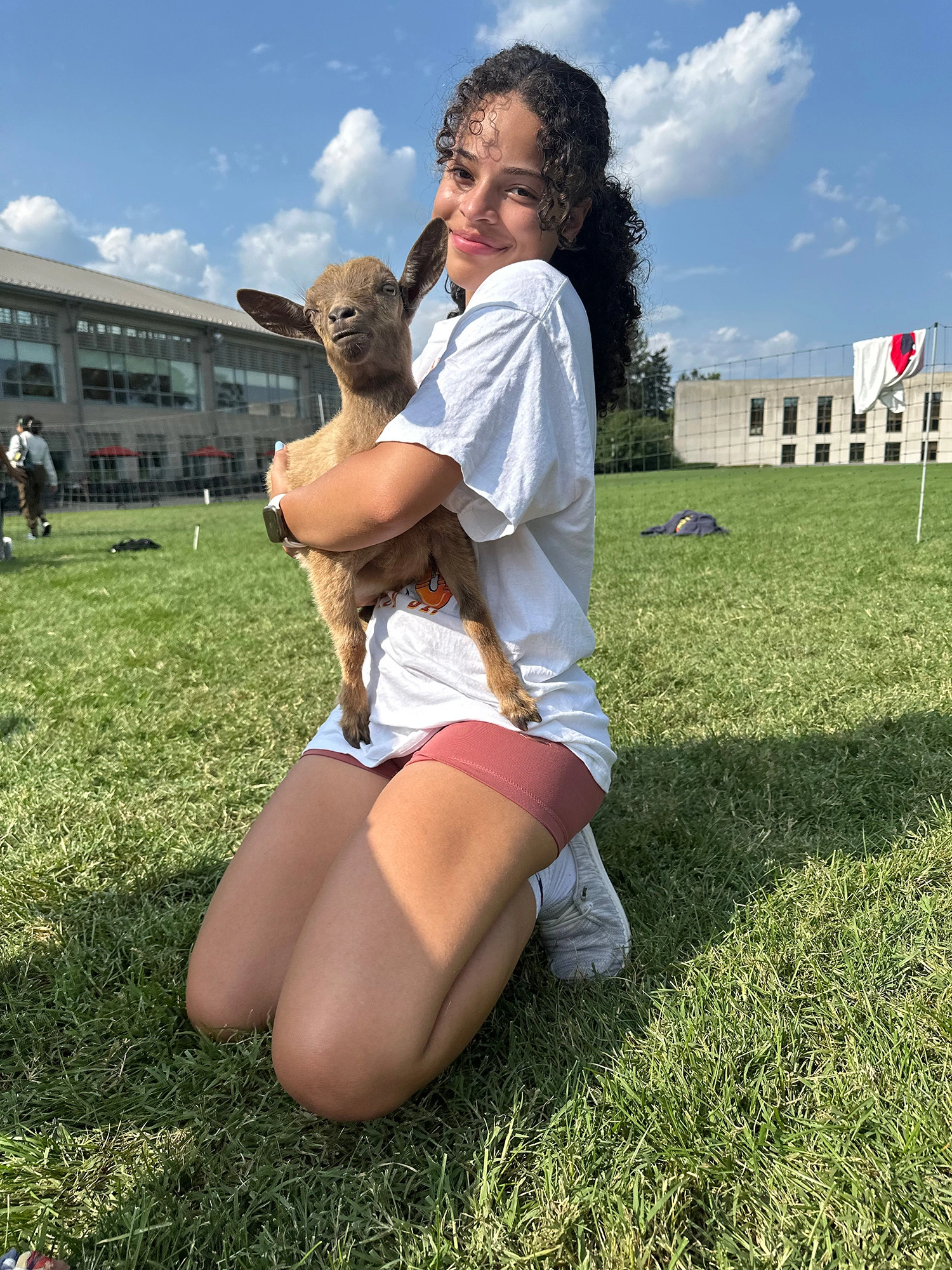 Milagro Duran ’27 holding a goat.