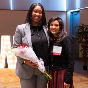 Aliyah Abraham '17 holds flowers while standing next to Arcadia Ambassador Paayal Nair at the 2024 Women Who Lead Forum