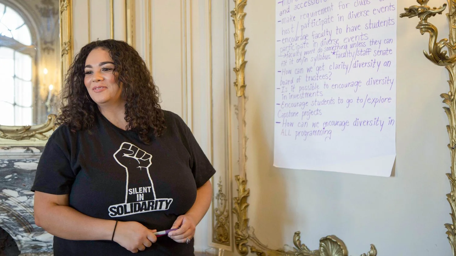 A person wearing a Black Lives Matter shirt and highlighting diversity