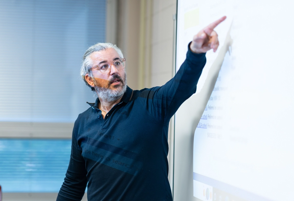 A professor giving a lecture and using powerpoint