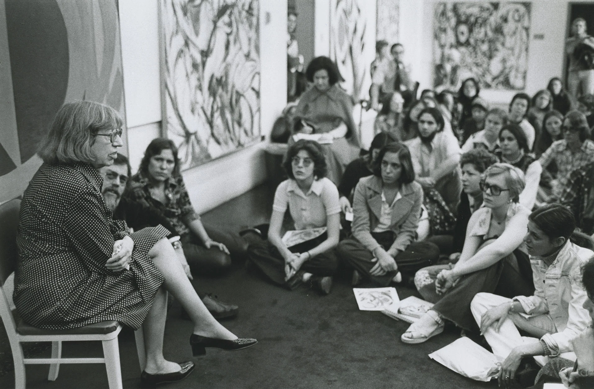 Lee Krasner, artist, lecturing to a group of students in the exhibition space.