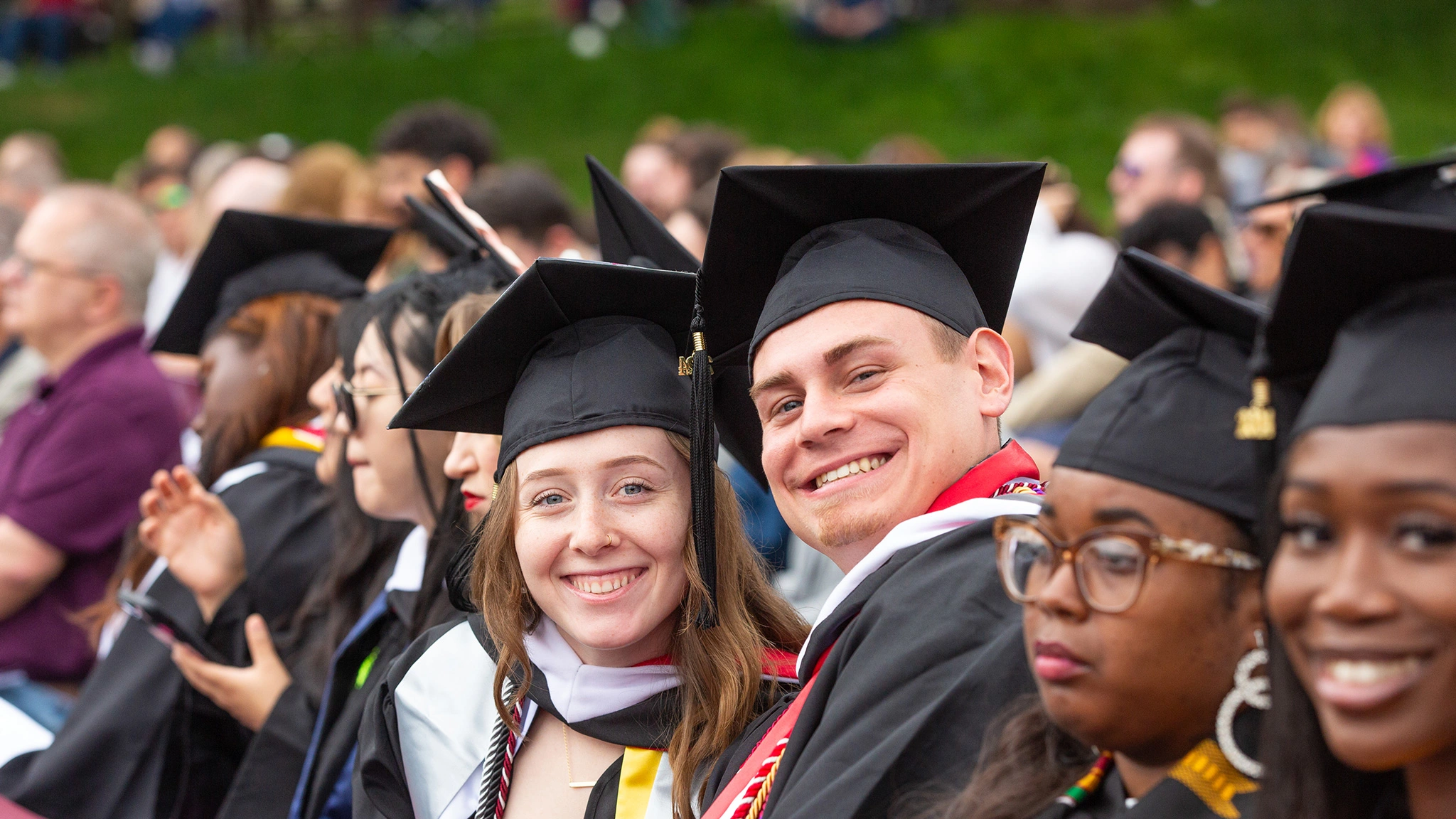 A crowd of students are all smiles as they set outside during ceremonies at Arcadia.