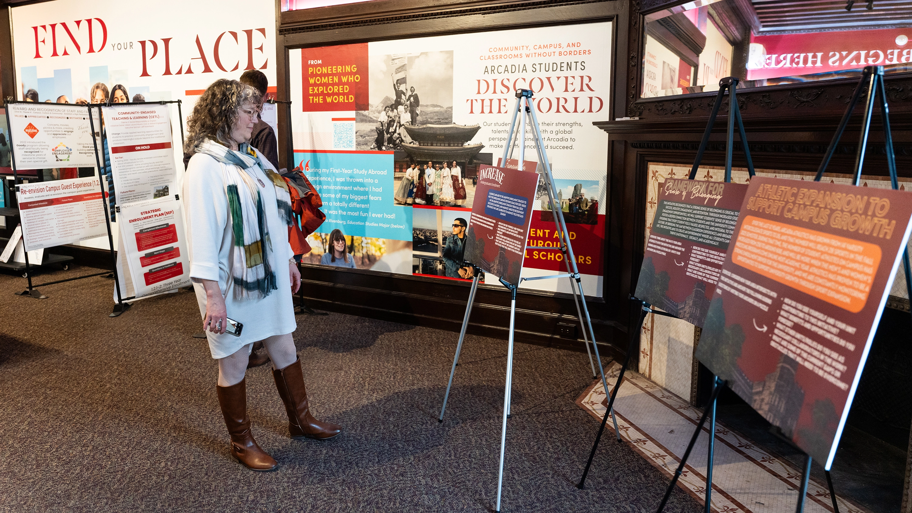 A woman reads a sign display during the idea sessions for the Gallery Walk event.