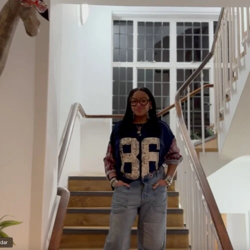 Jamai Vann ’28 standing on the stairs of the Elizabeth House.