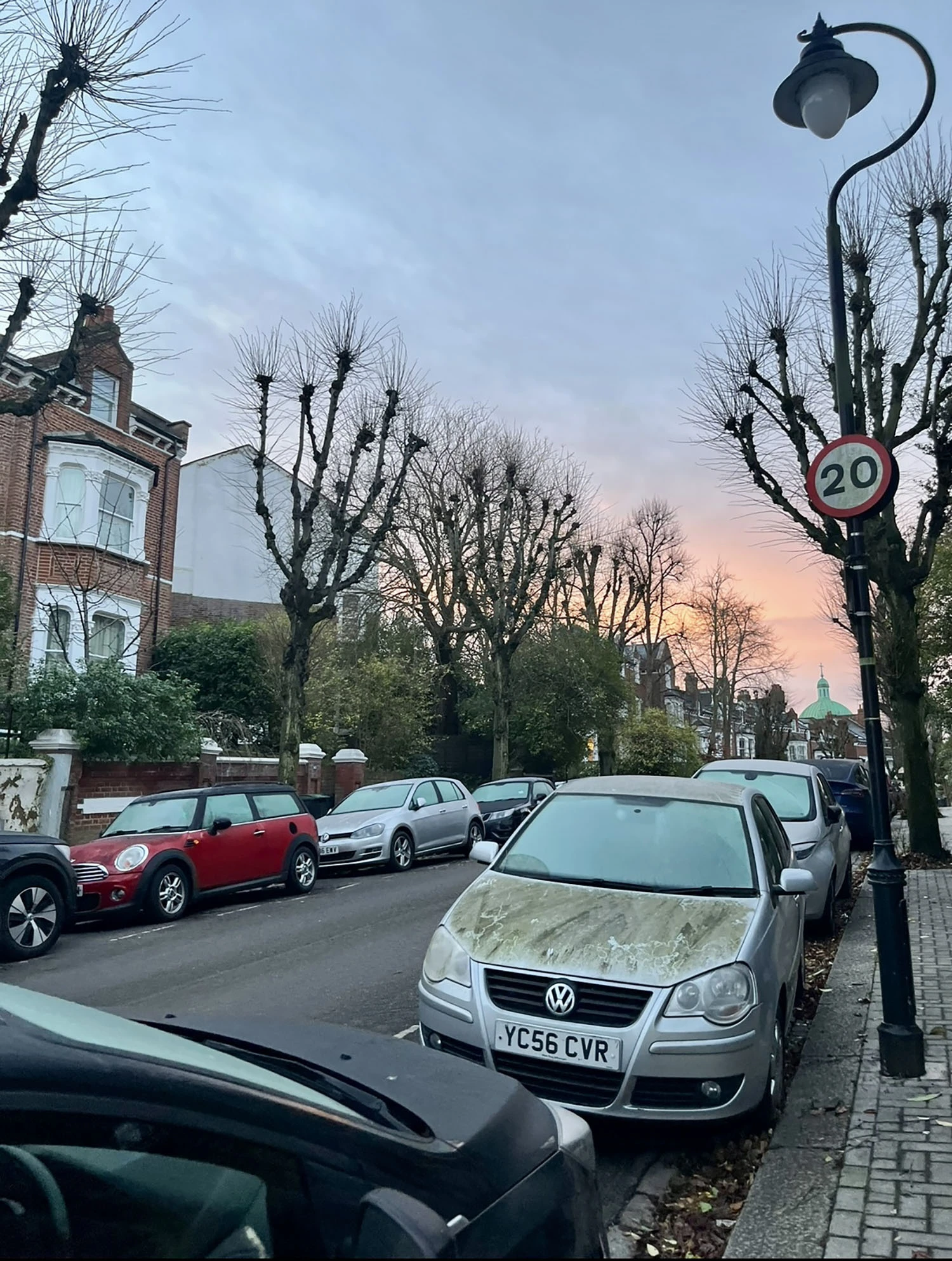 Cars lined on the street in London.